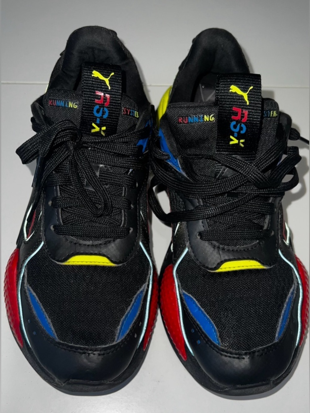Puma Black Sneakers with Red, Blue & Yellow Accents